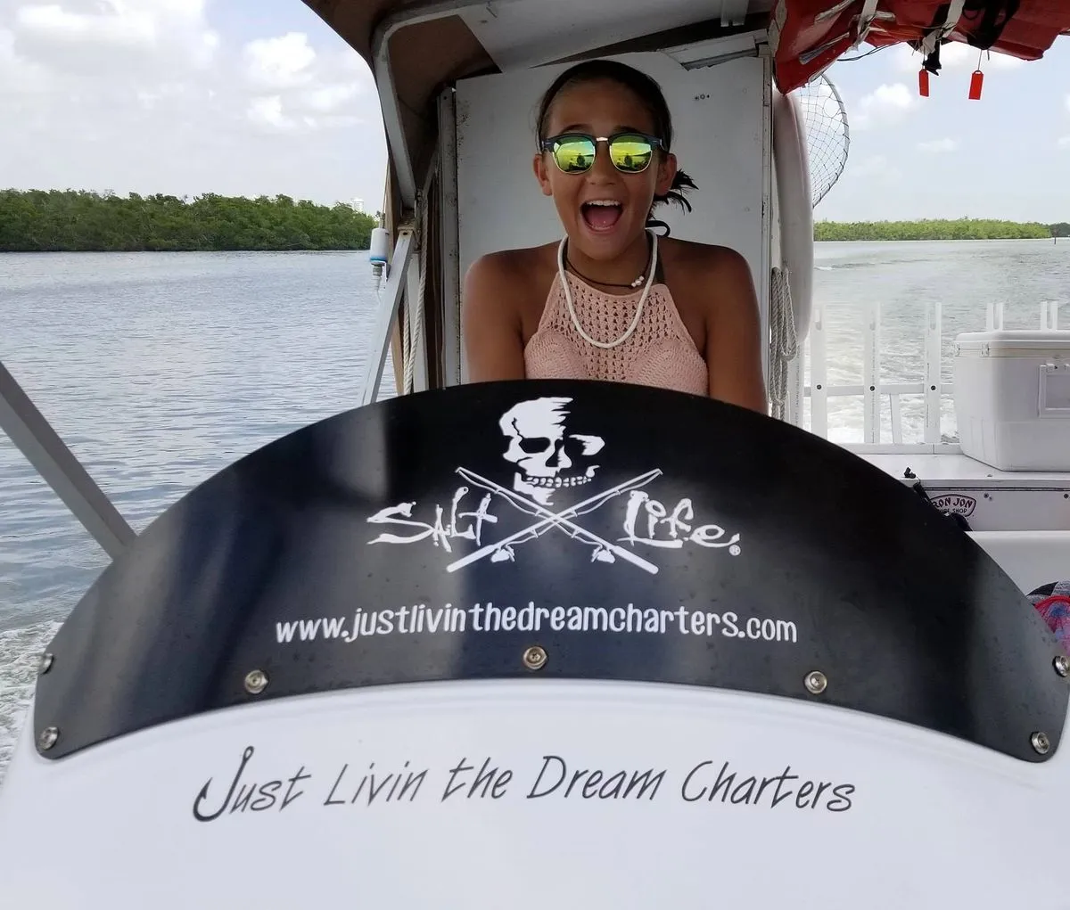 Family showing off their catch on a Bonita Springs fishing charter